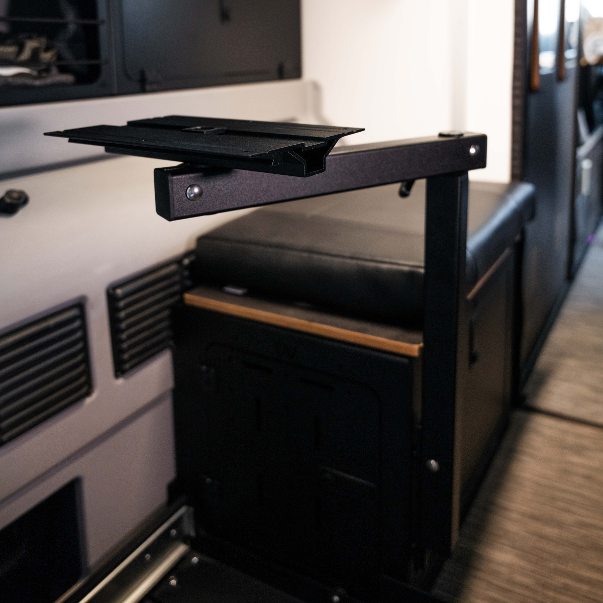 Overland vehicle interior with modular metal mounting bracket and storage seating