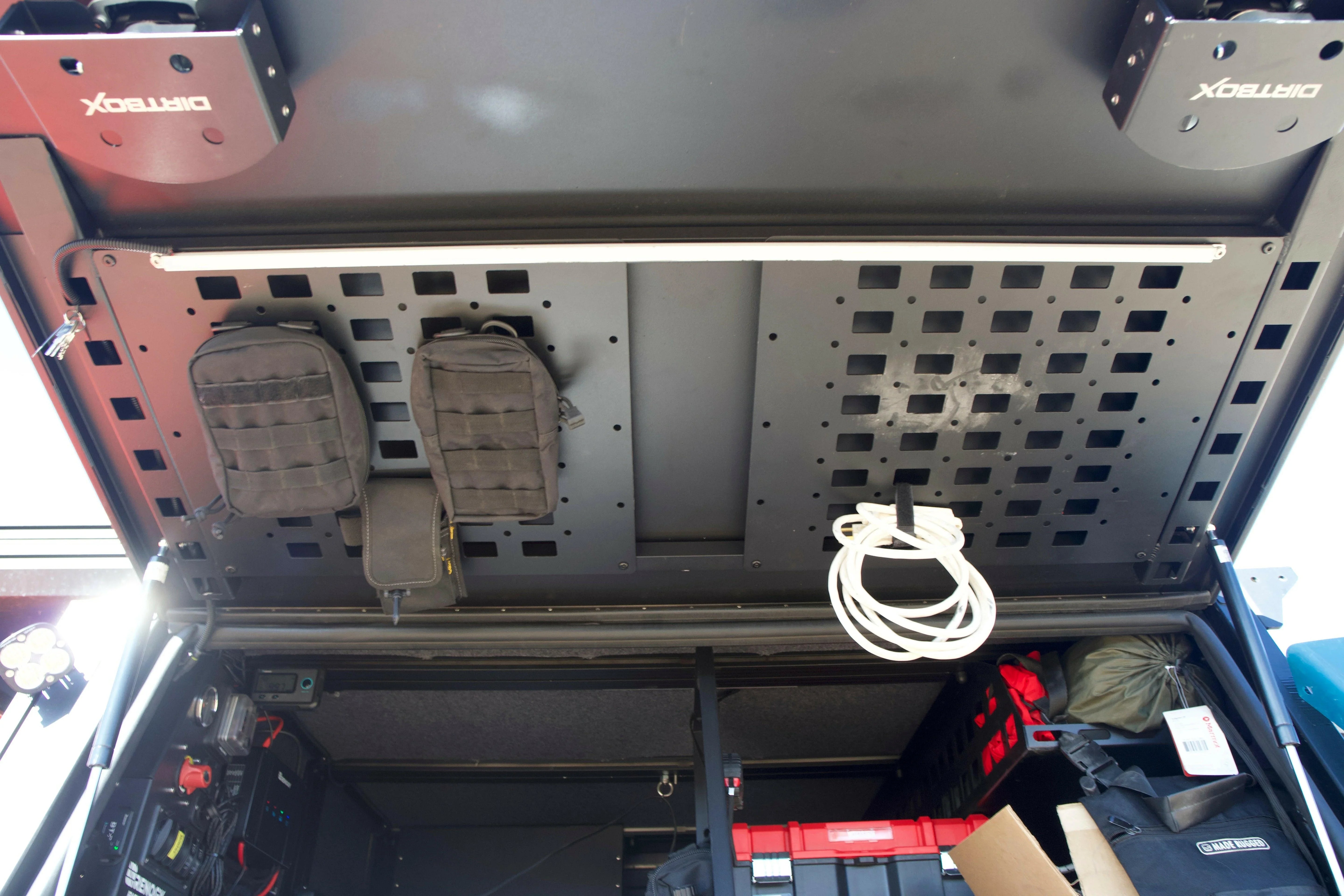 Overlanding vehicle storage system with MOLLE panels, gear pouches, and DIRTBOX mounts