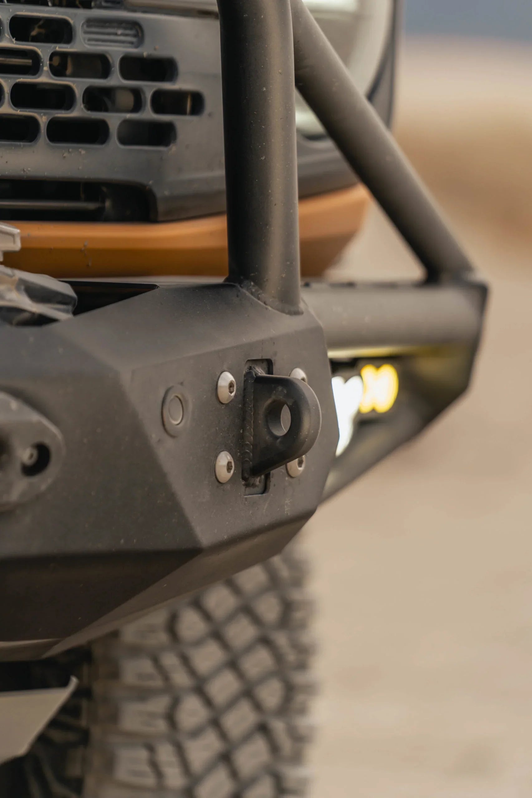 Close-up of off-road steel front bumper with recovery point on a rugged vehicle