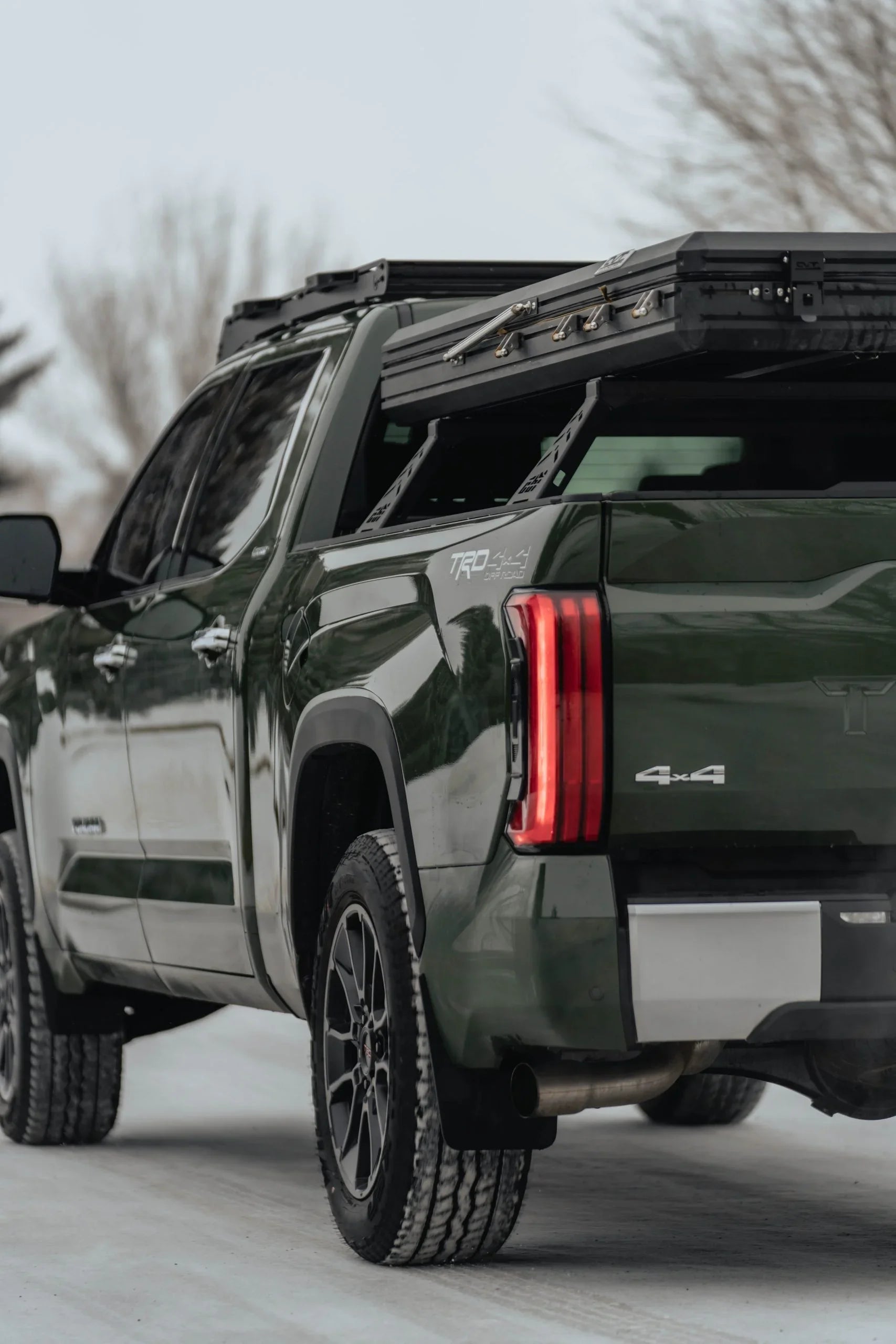 Toyota Tundra TRD 4x4 with roof rack and overlanding gear on snowy road