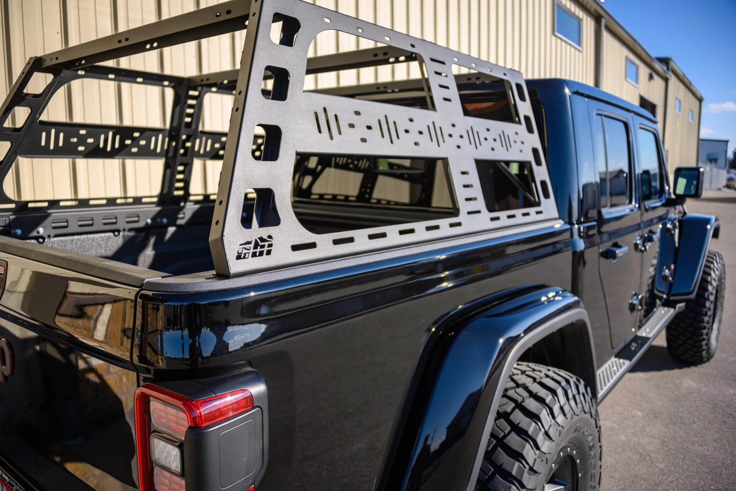 Black Jeep Gladiator with modular bed rack for overlanding and expedition gear