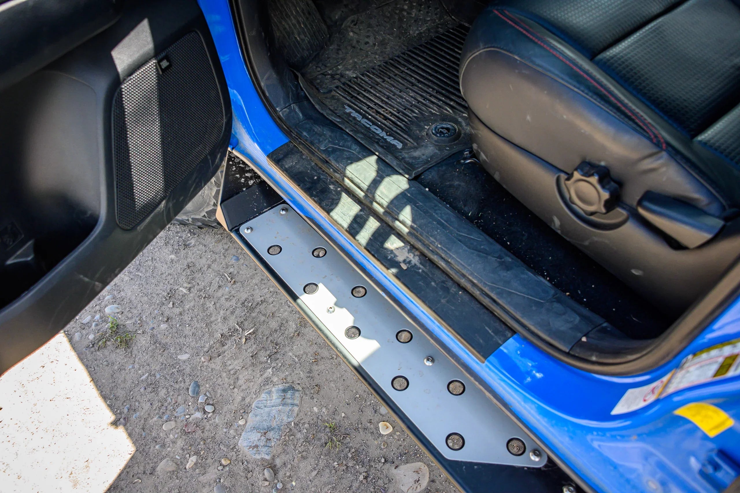 Toyota Tacoma metal door sill plate and black step, off-road ready interior detail