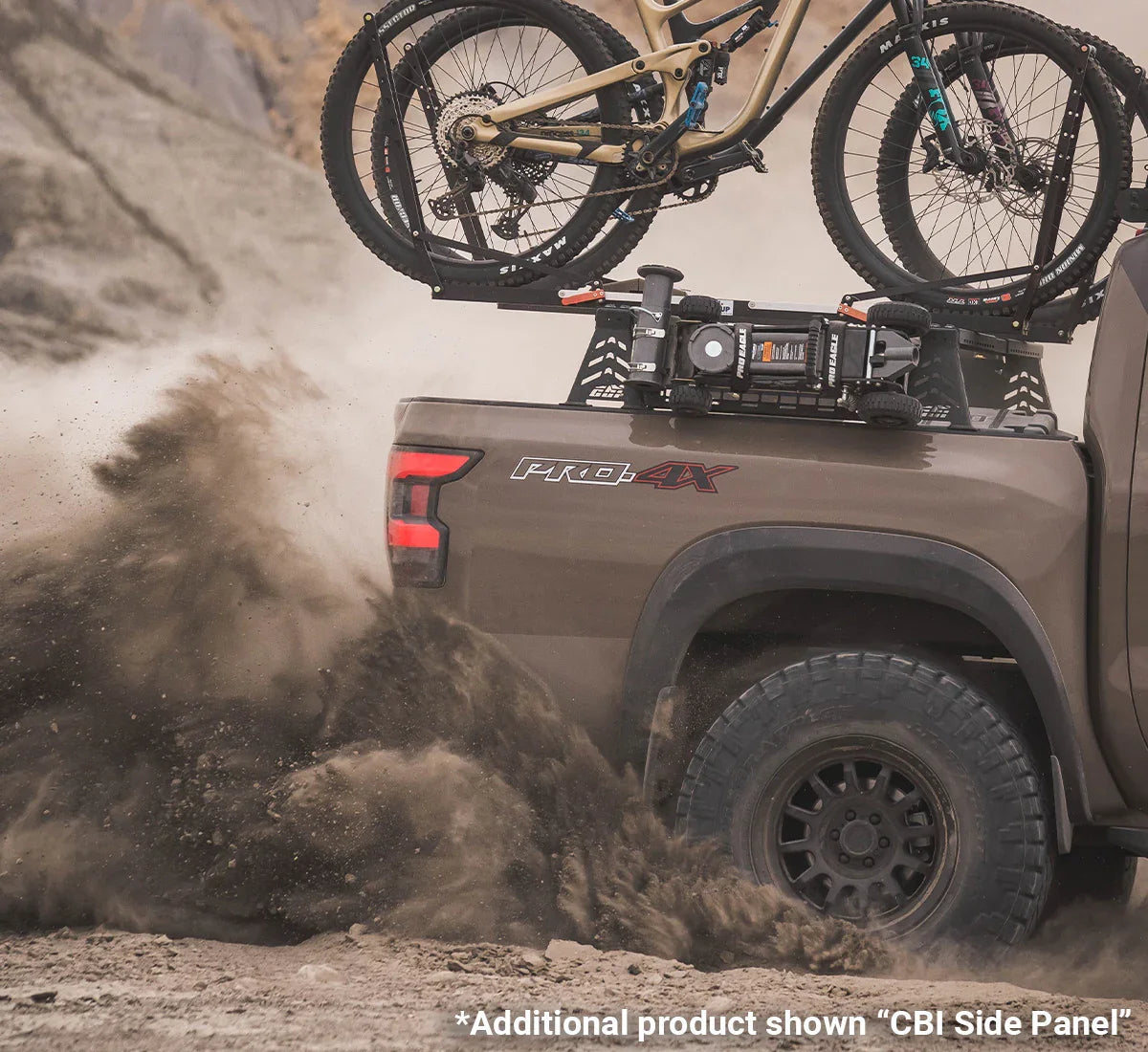 Pickup truck off-roading with bike rack and mountain bikes, dust flying from rear tires