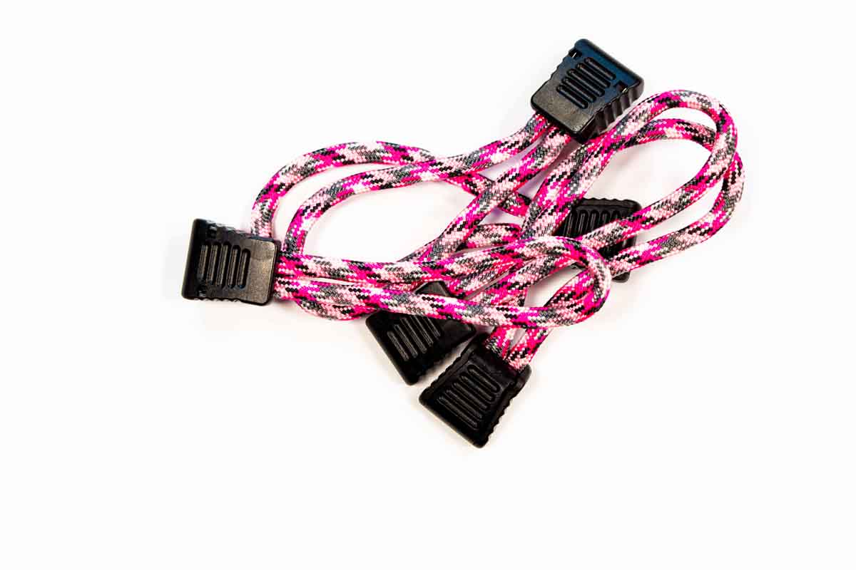Pink and black paracord tie-down straps with plastic clips for overlanding gear