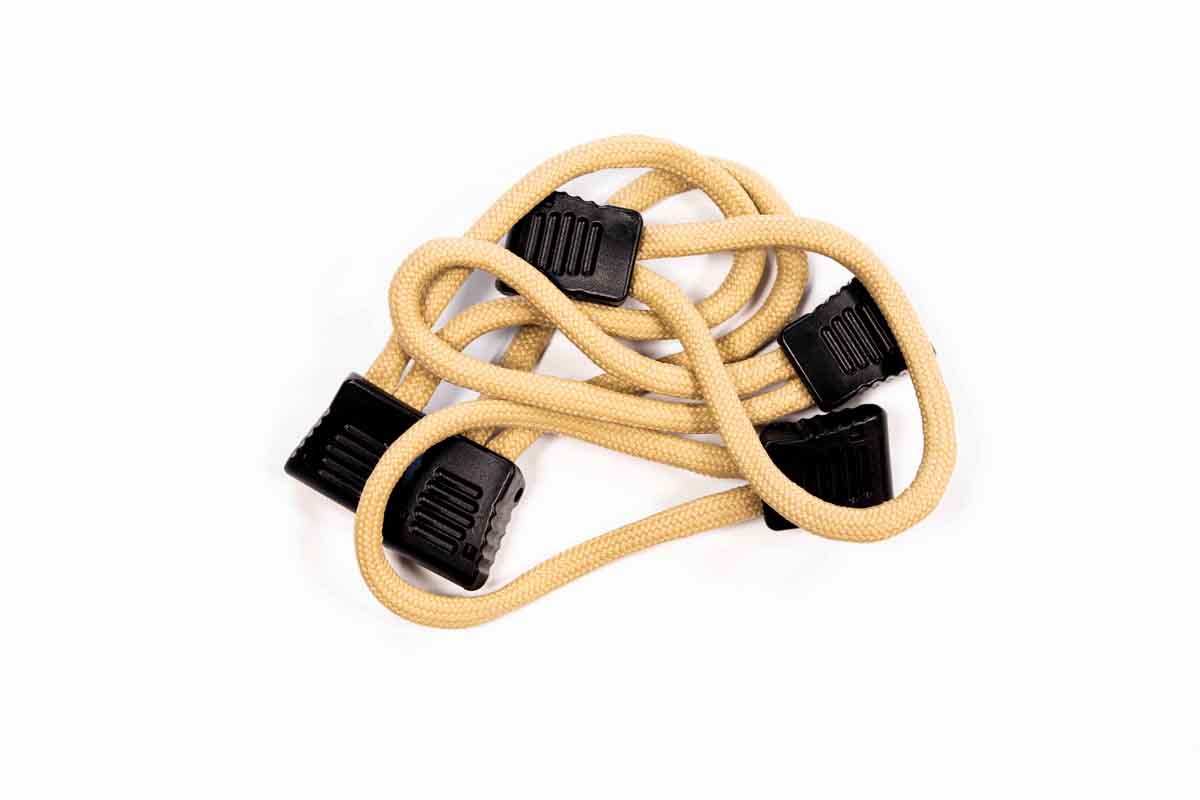 Tan bungee cord with black plastic hooks for overlanding gear and camping vehicle accessories