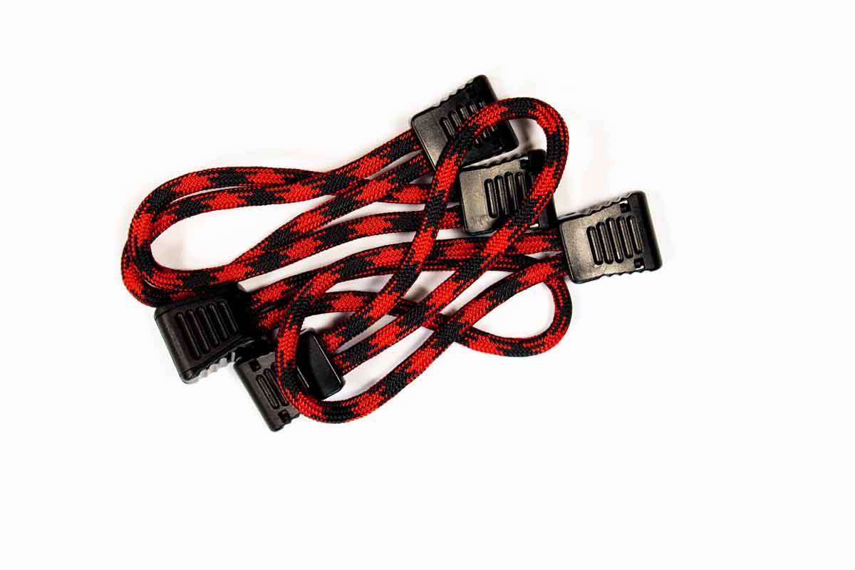 Red and black braided bungee cords with black plastic hooks for overlanding and camping gear