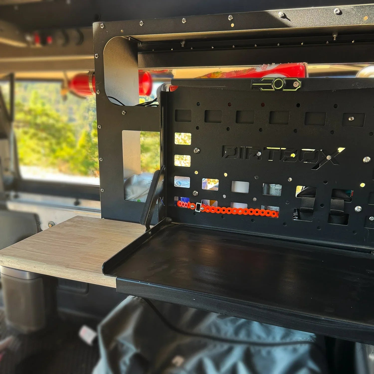 Overland vehicle storage system with fold-down metal and wood utility table inside SUV