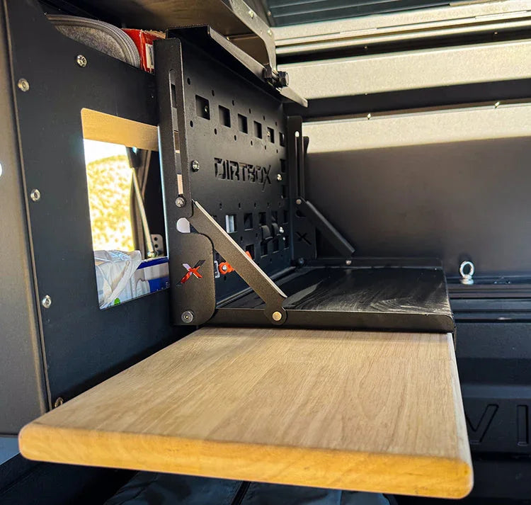 Folding metal and wood camping shelf installed in an off-road vehicle interior