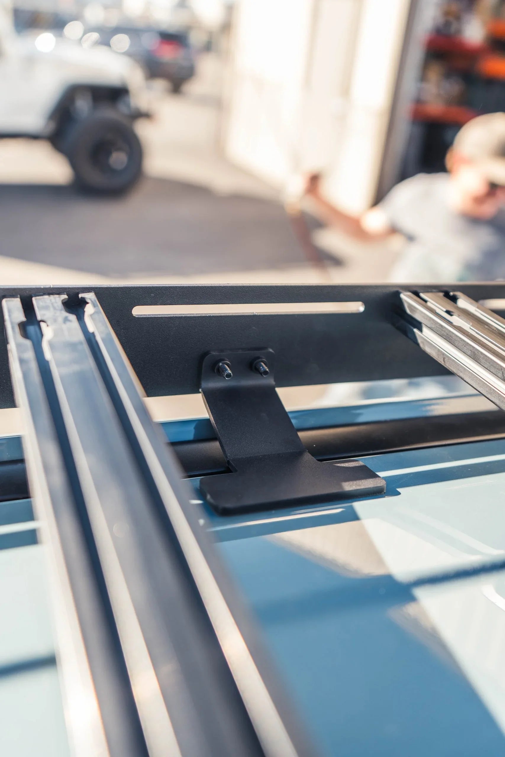 Close-up of a Ford Maverick roof rack mounting bracket, outdoor automotive accessory