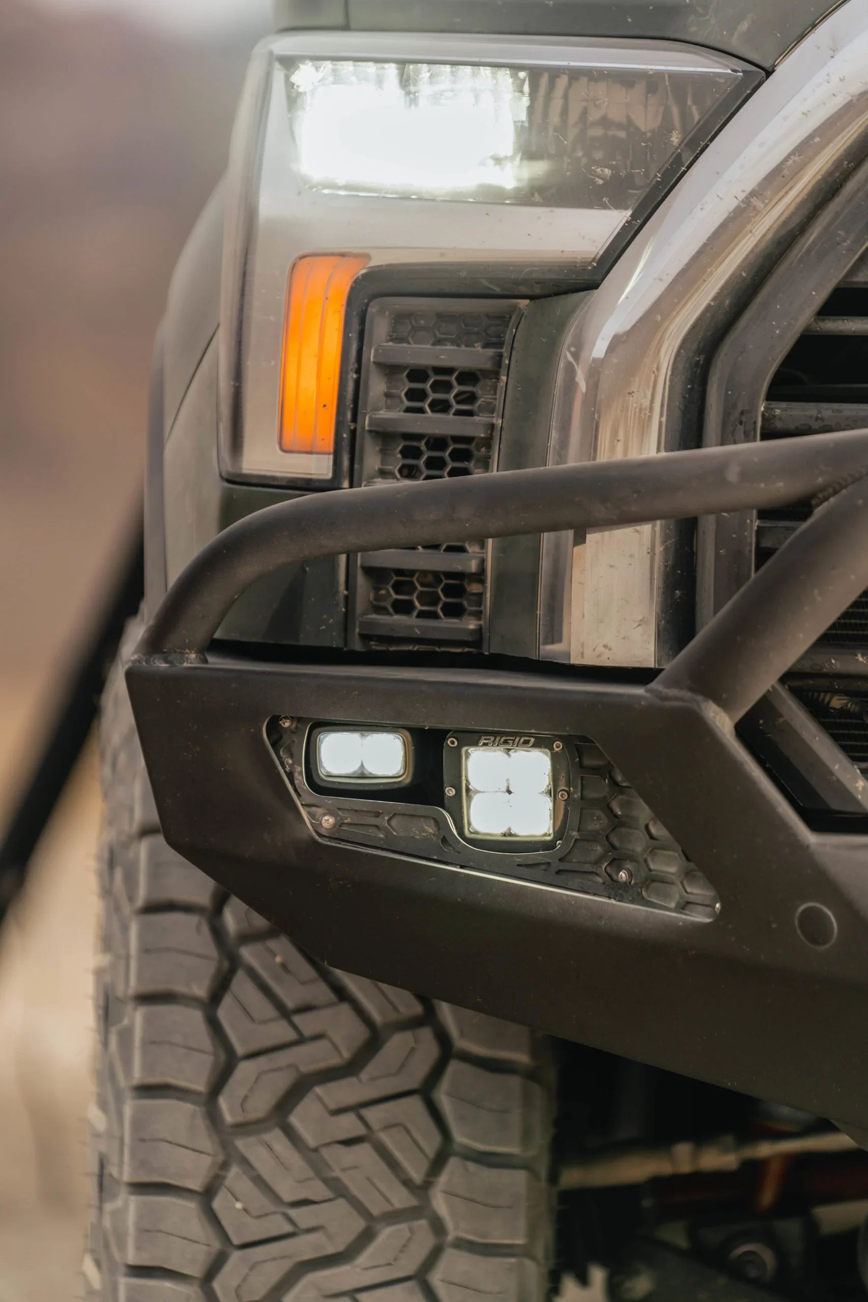 Toyota Tundra front bumper with off-road LED lights and rugged tire detail