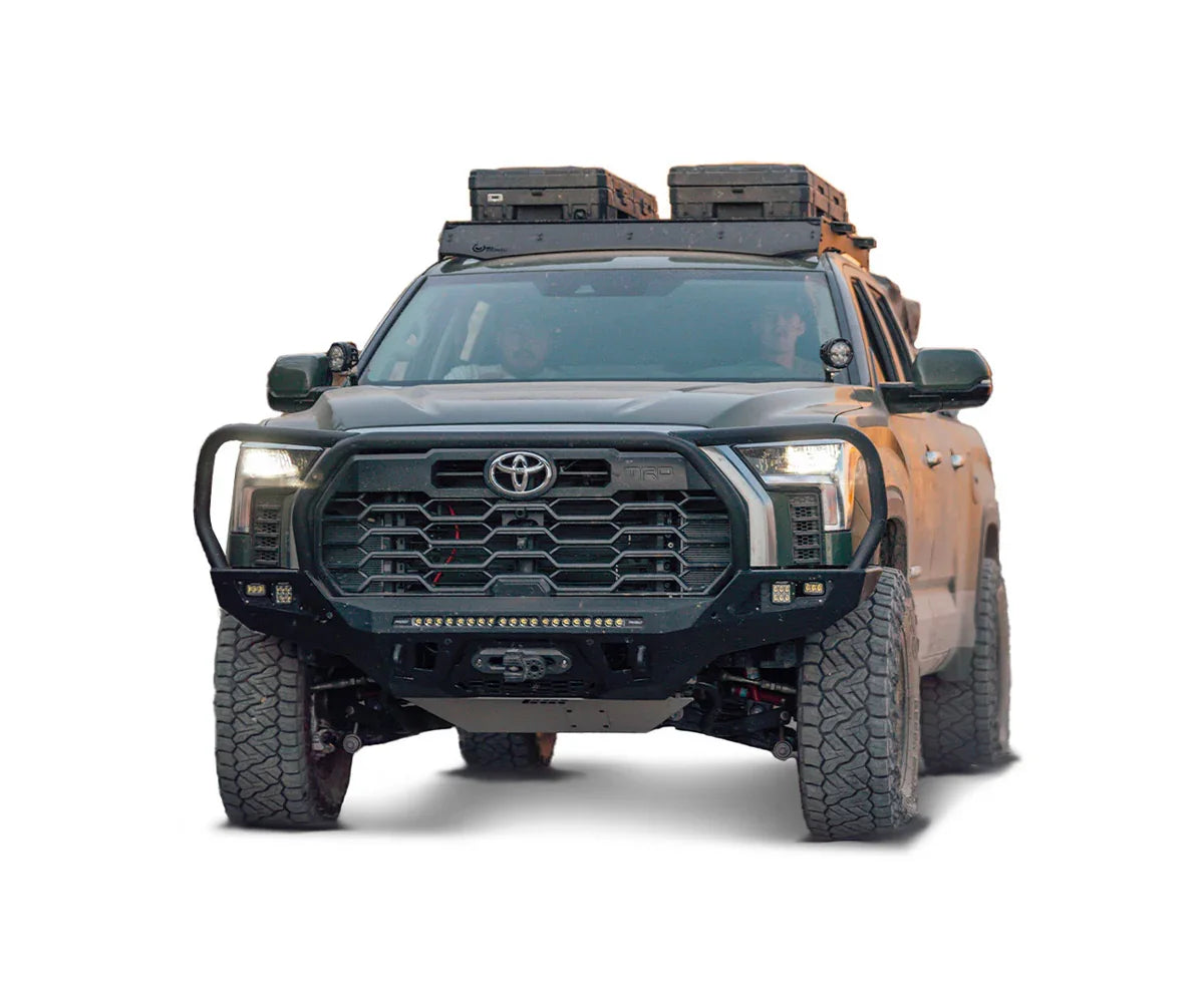 Toyota Tundra equipped with off-road front bumper, large tires, and roof gear boxes