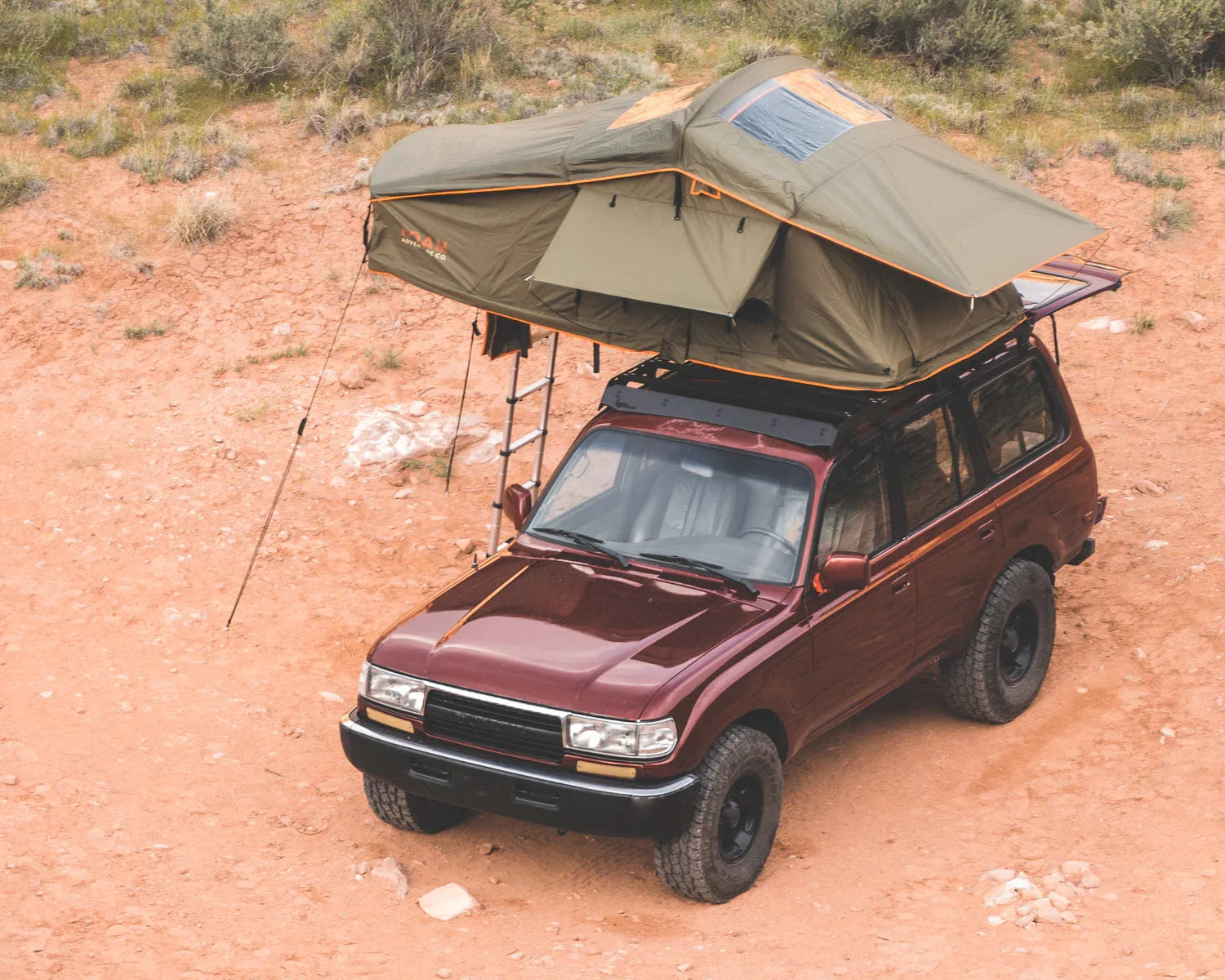 SUV with roof top tent for overlanding and camping on a desert trail