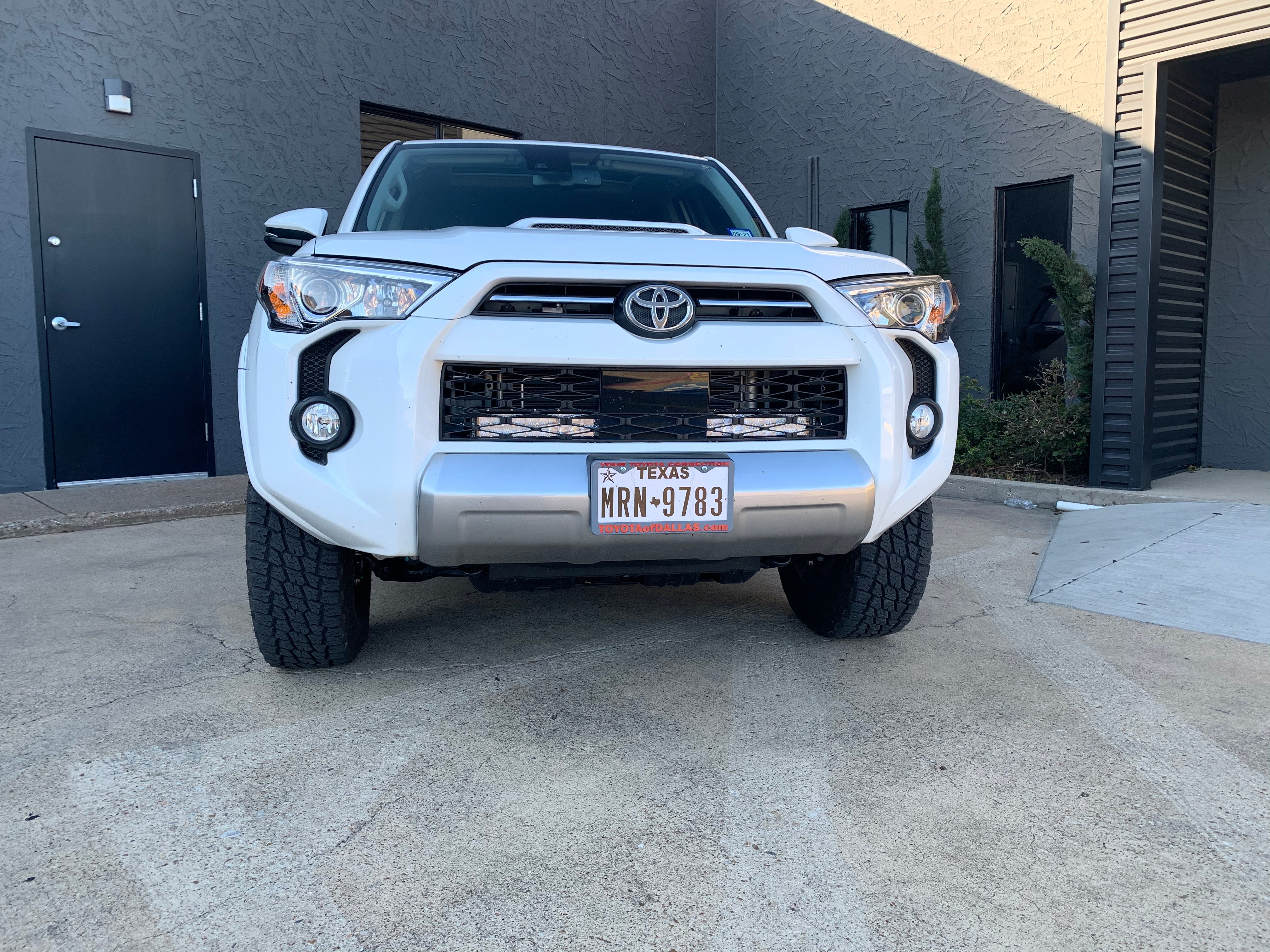 Front view of a white Toyota 4Runner SUV parked outdoors, ready for overlanding adventure.