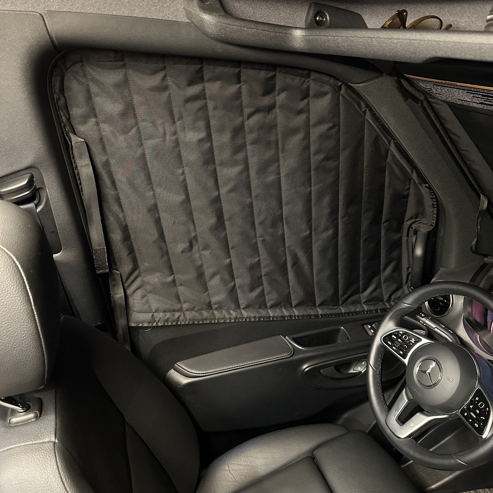 Insulated blackout window cover installed on a Mercedes vehicle driver side window