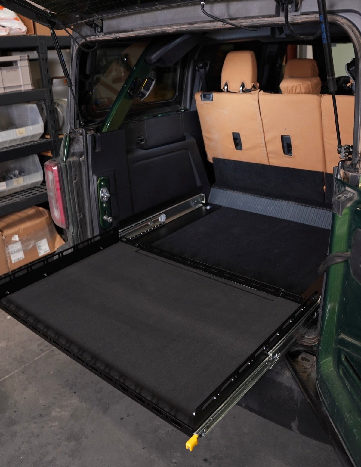 Diabolical Inc Slide Floor 2.0 extended from a Ford Bronco 4-door