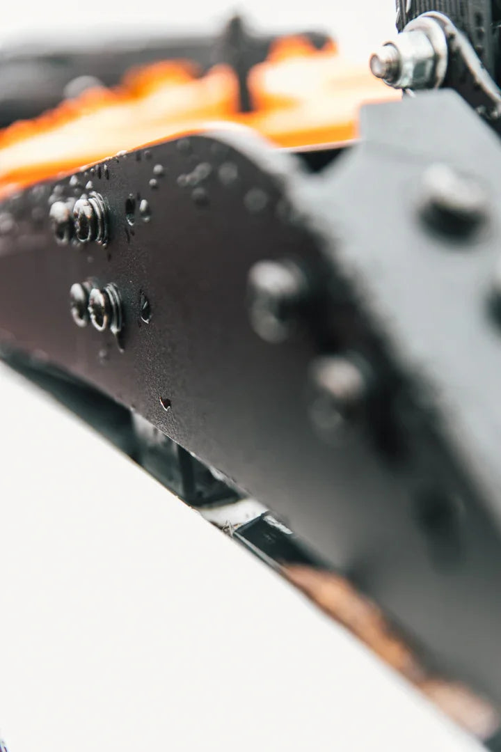 Close-up of rugged black metal vehicle accessory with bolts, wet from rain, for overlanding