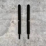 Pair of black breakaway mirror arms for Jeep Wrangler doors-off setup on concrete surface