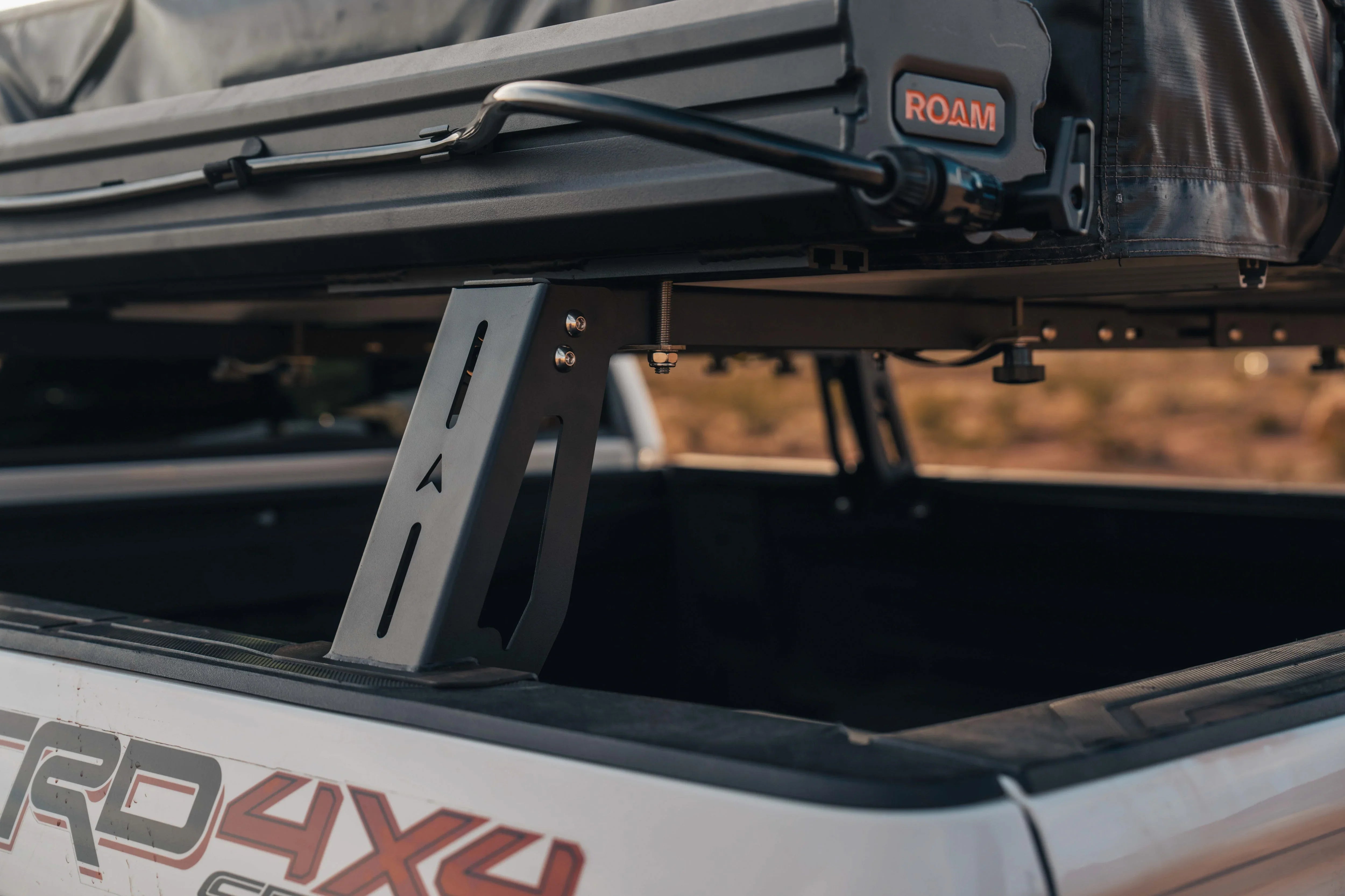 Truck bed rack mounting a rooftop tent on Toyota TRD 4x4, overlanding gear setup