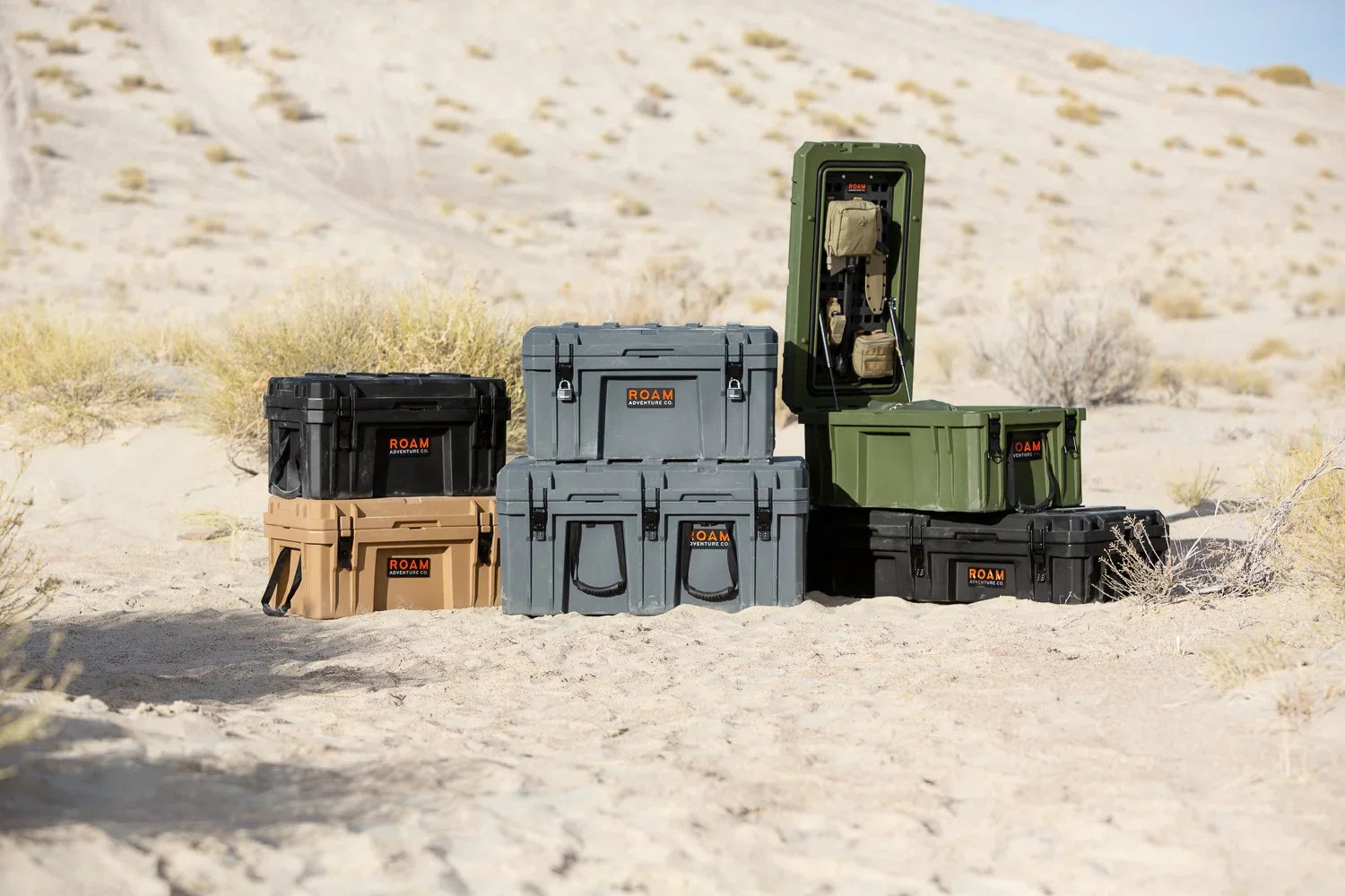Stacked ROAM Adventure Co. storage cases for overlanding and camping in desert outdoors.