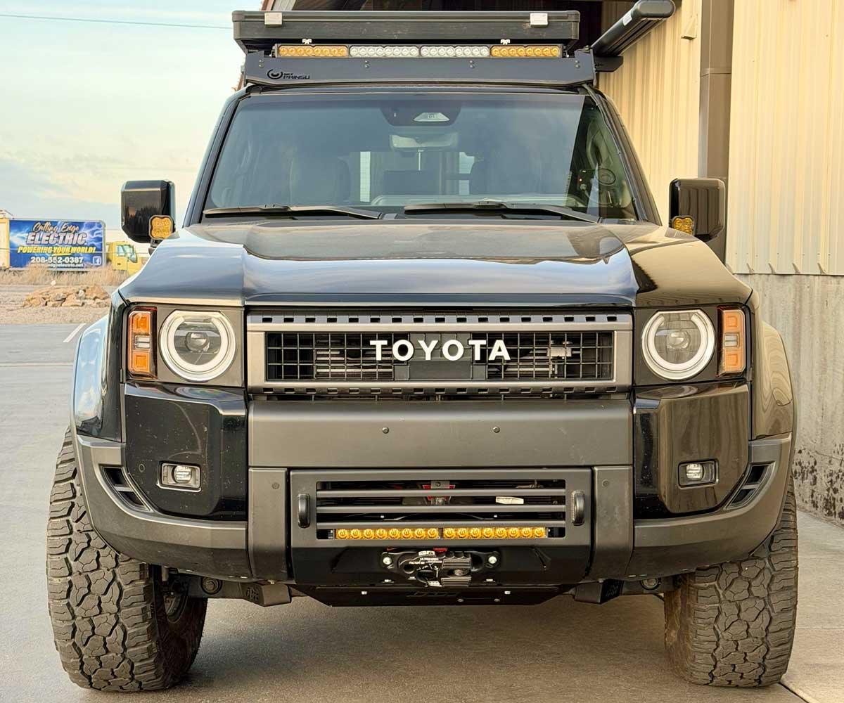 Front view of an off-road modified Toyota SUV with LED light bars and rugged tires