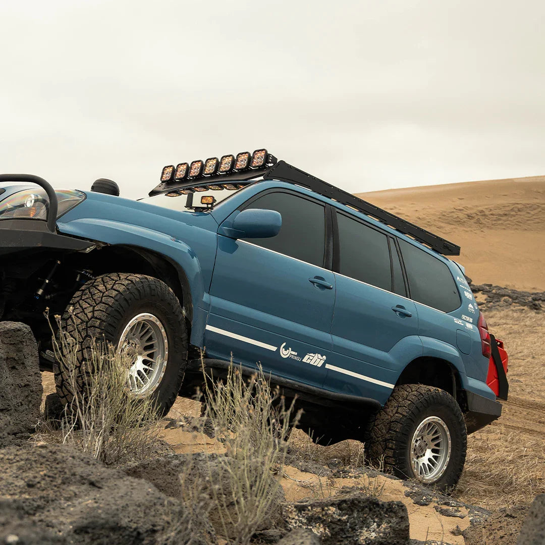 Lexus GX470 with Prinsu Pro roof rack and off-road lights on rocky desert terrain