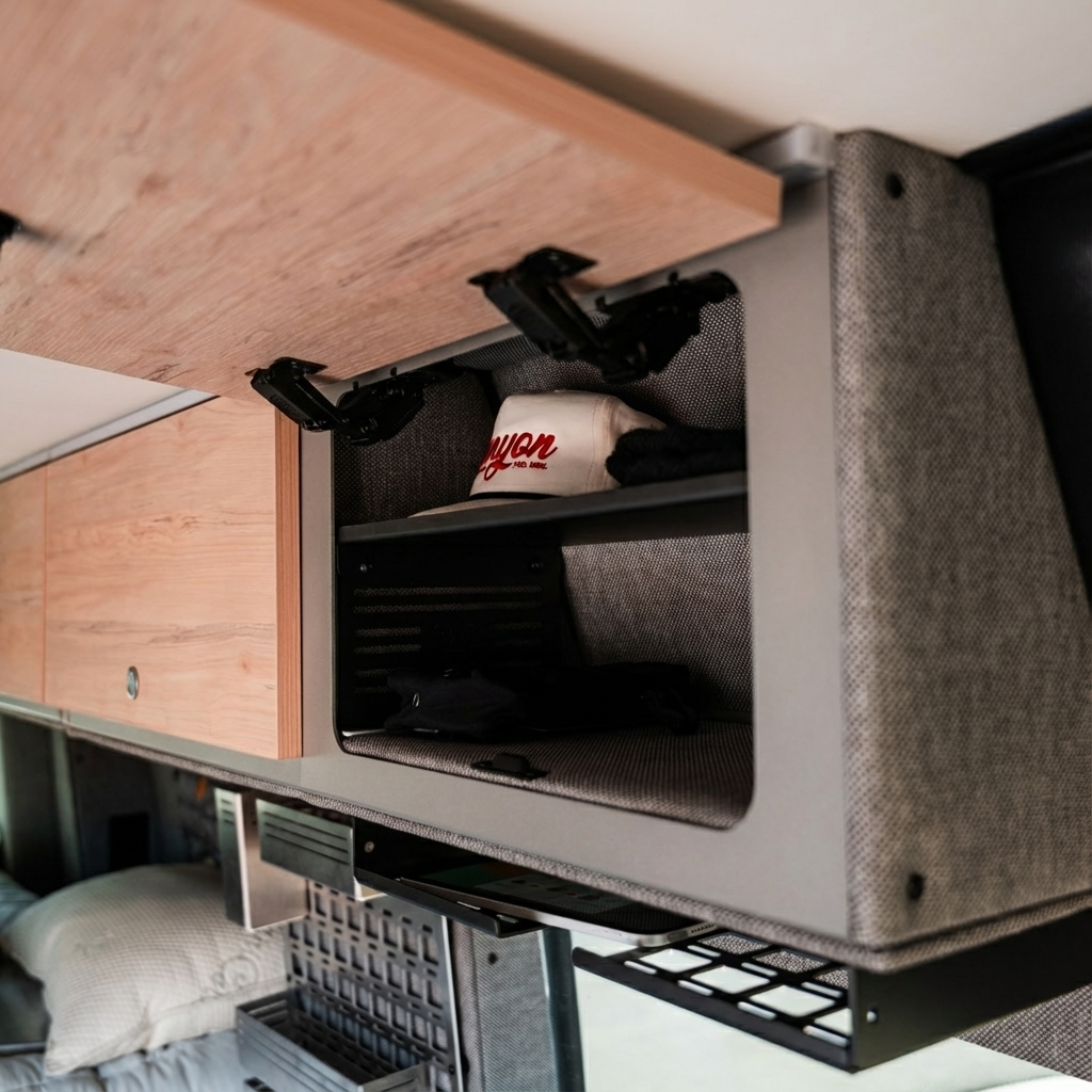 Overland vehicle overhead storage cabinet with open door showing organized gear inside