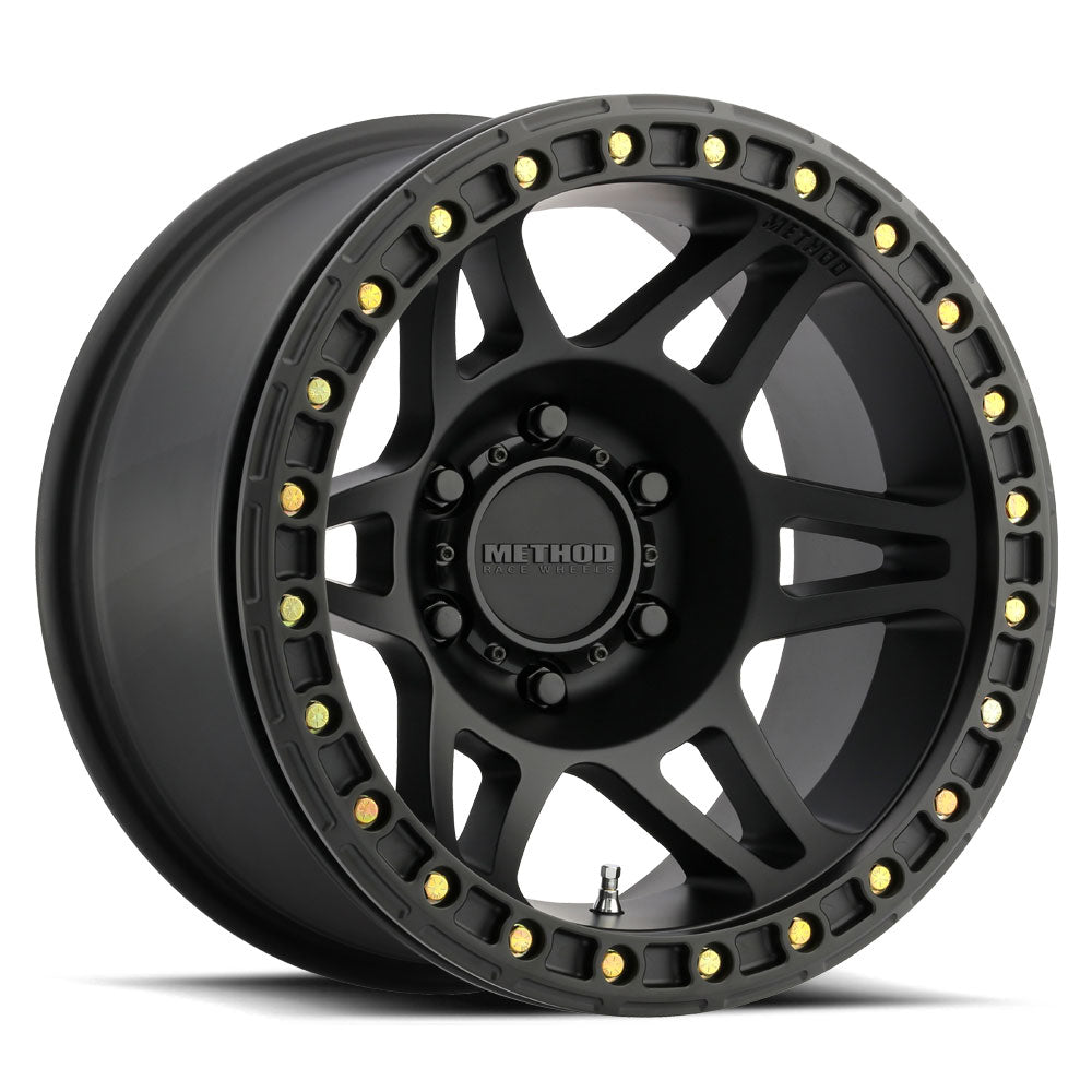 Matte black beadlock off-road wheel with multi-spoke design and gold bolts