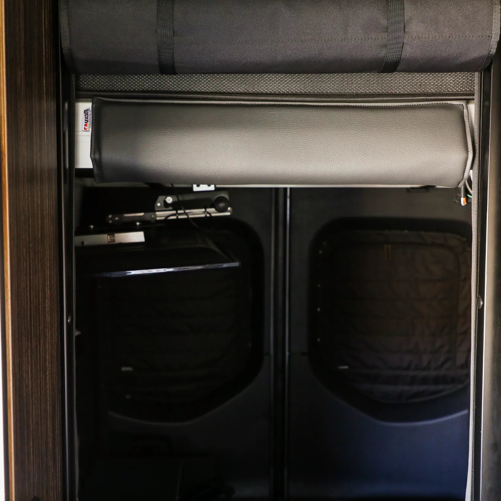 Padded bed head bumper installed inside an overlanding camper or expedition vehicle