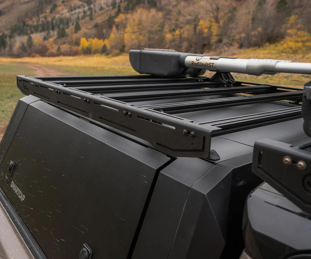 Aluminum roof rack with mounted gear on an overland vehicle in a scenic outdoor setting