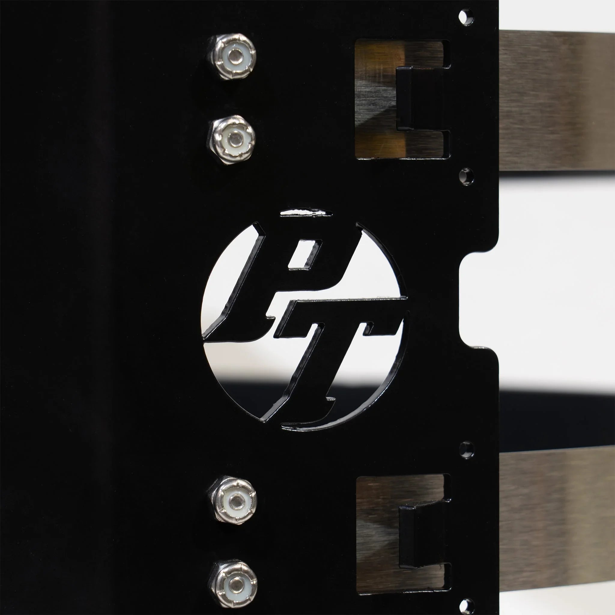 Close-up of a black powder-coated metal vehicle mounting bracket with PT logo and hex bolts