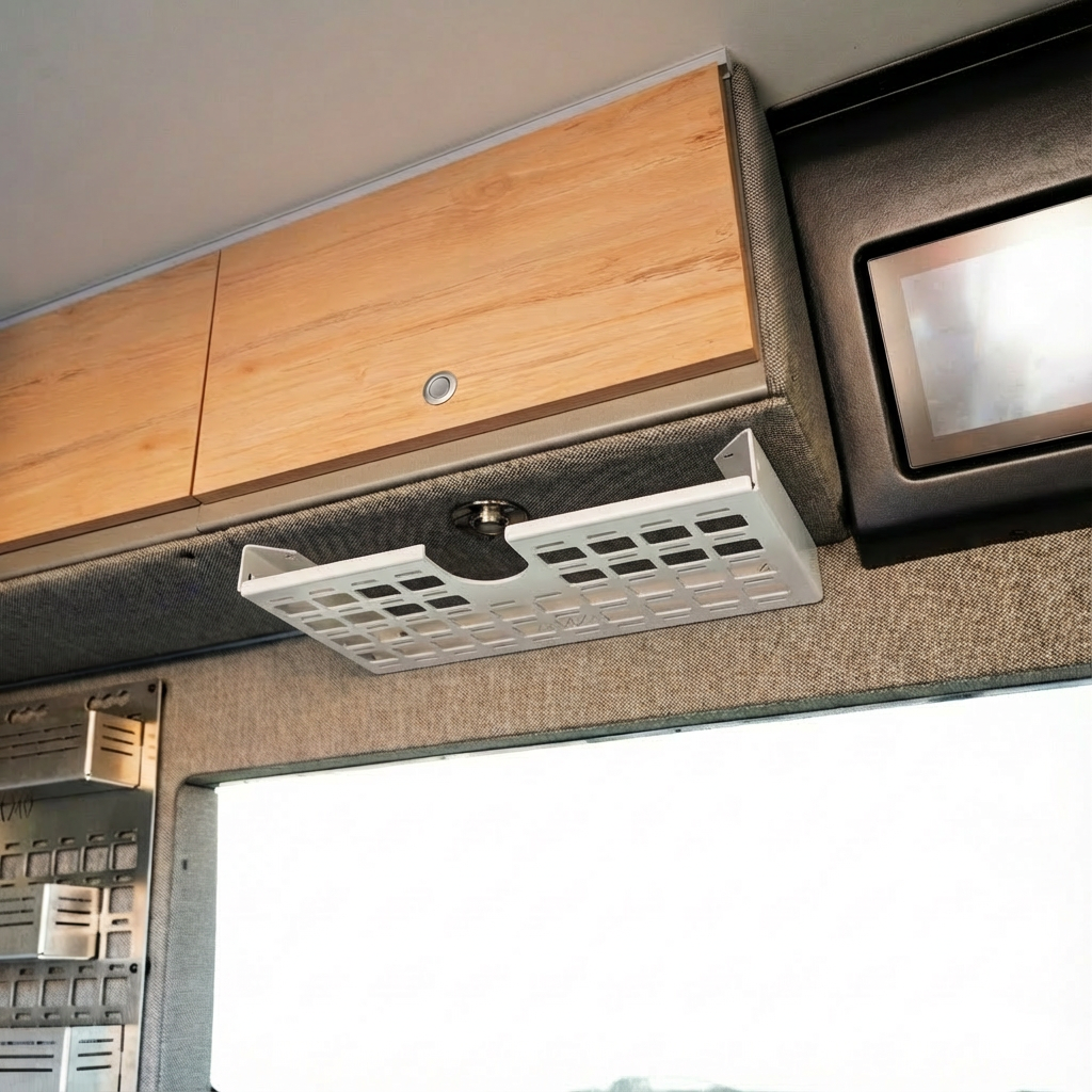 Overland vehicle interior with metal overhead storage basket and wood cabinets