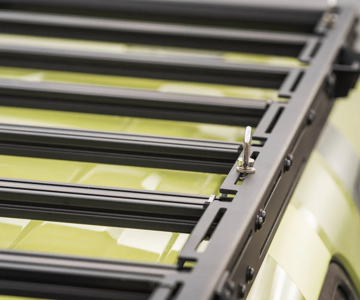 Close-up of black roof rack on Toyota 4Runner with yellow paint, overlanding gear accessory