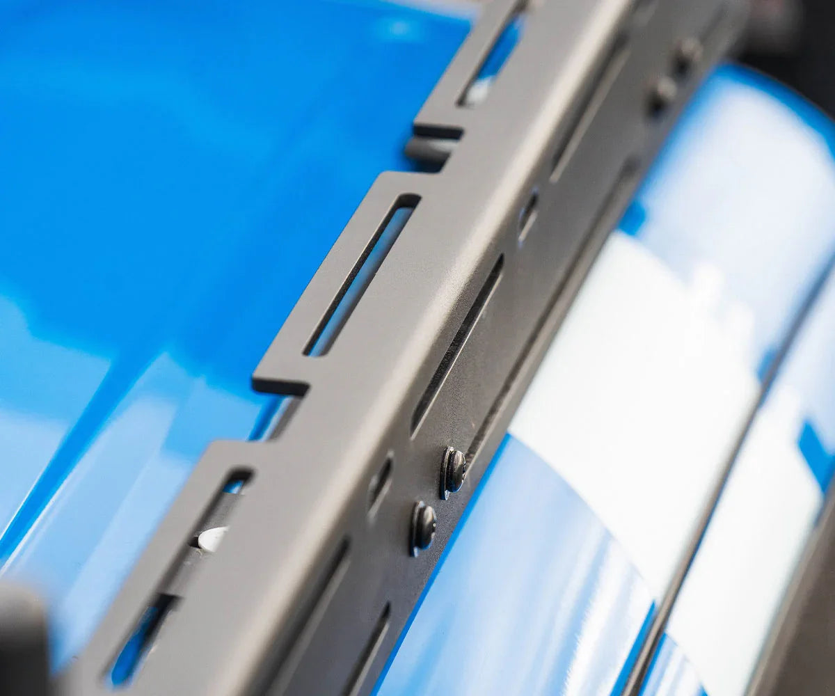 Close-up of black roof rack mounted on blue Toyota Tacoma, overlanding accessory detail