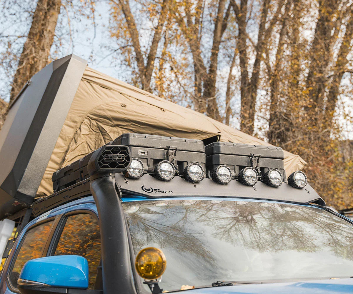 Toyota Tacoma with rooftop tent, Prinsu roof rack, and overlanding storage cases