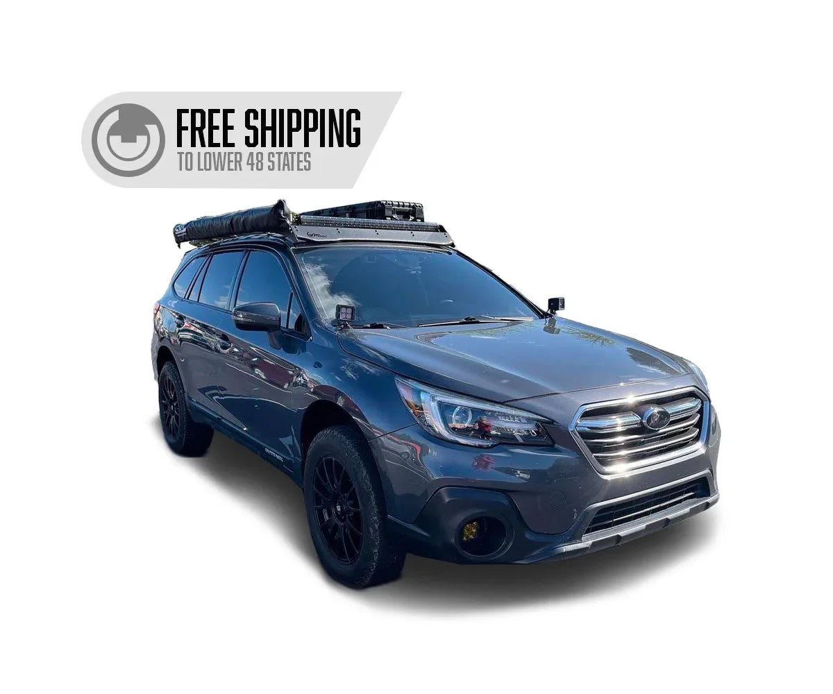 Subaru Outback with roof rack, off-road lights, awning, adventure vehicle accessories