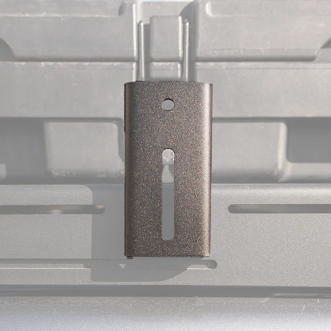 Metal awning mount bracket for overlanding roof rack, close-up on silver background