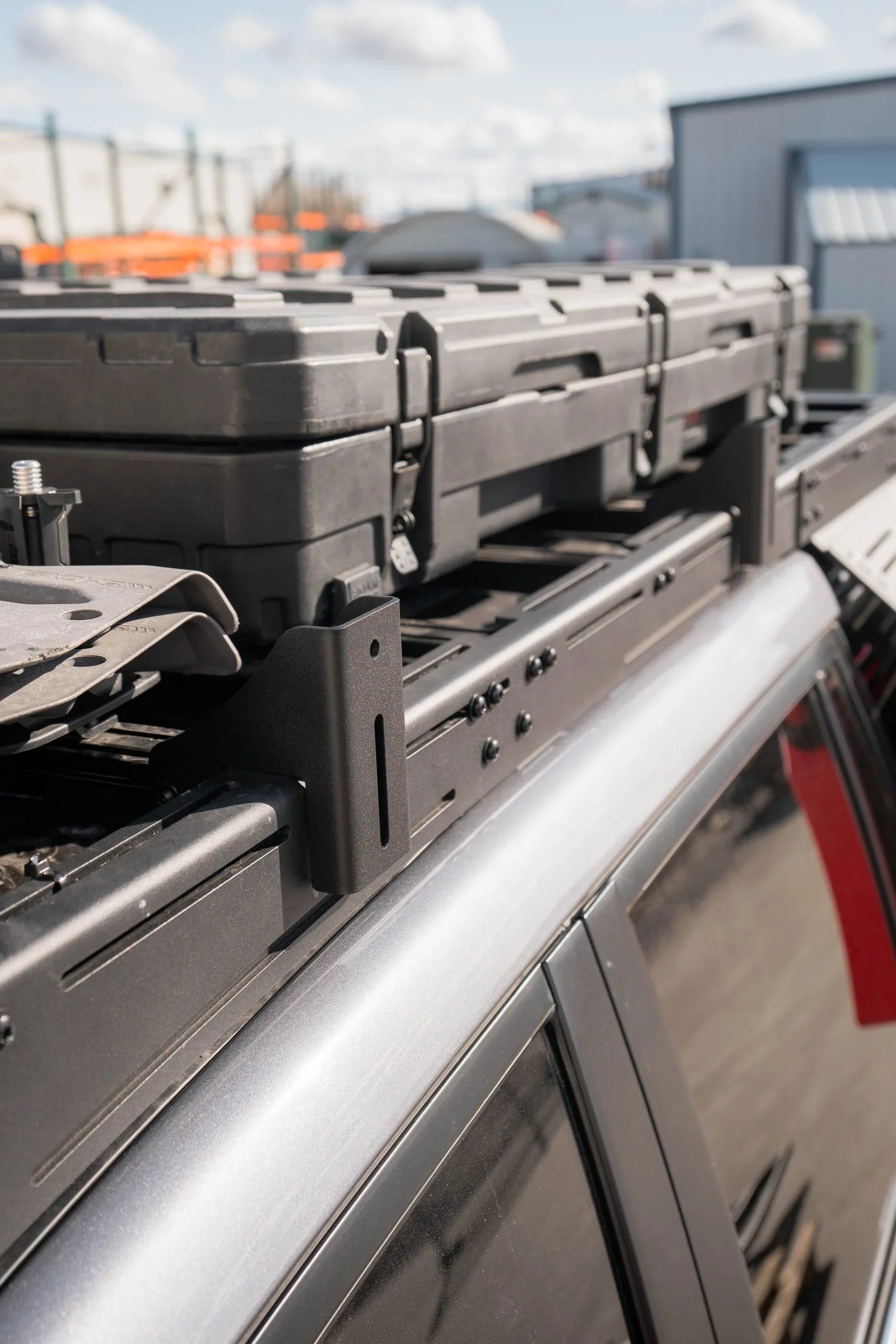 Close-up of pro awning mounts and rooftop gear storage rack on a vehicle