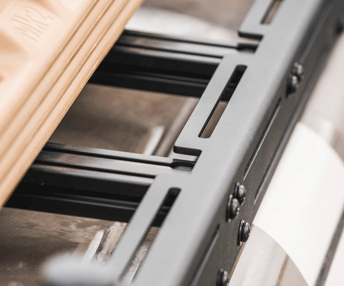 Close-up of heavy-duty roof rack crossbars and mounting brackets for off-road vehicles
