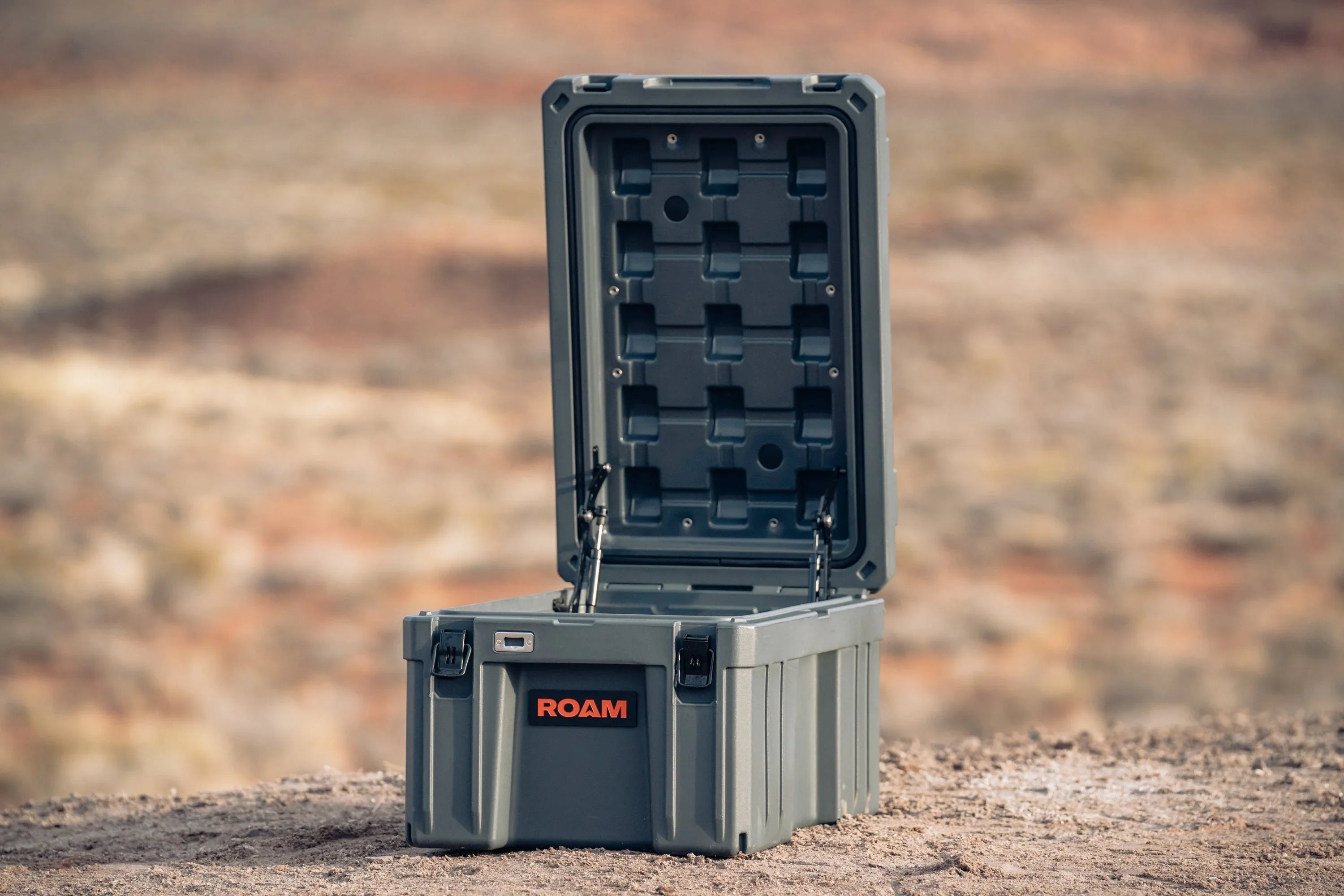 Rugged hard shell storage box with open lid for overlanding and camping outdoors