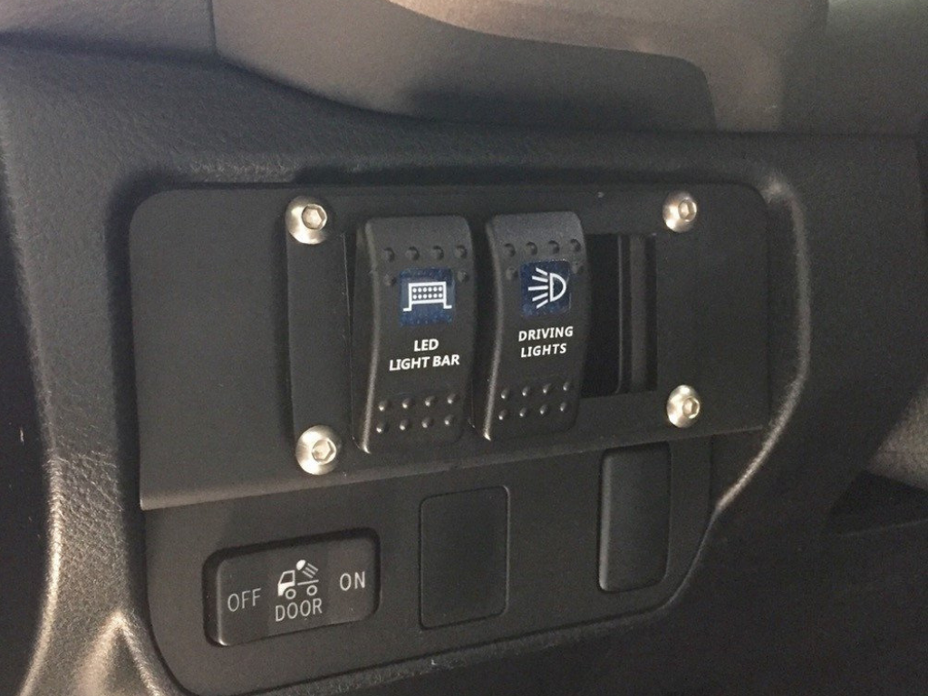 Dashboard panel with switches for LED light bar and driving lights in off-road vehicle