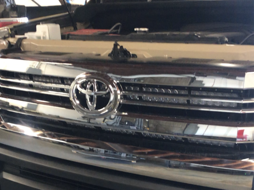 Toyota grille with chrome finish and custom LED light bars installed for off-road vehicles
