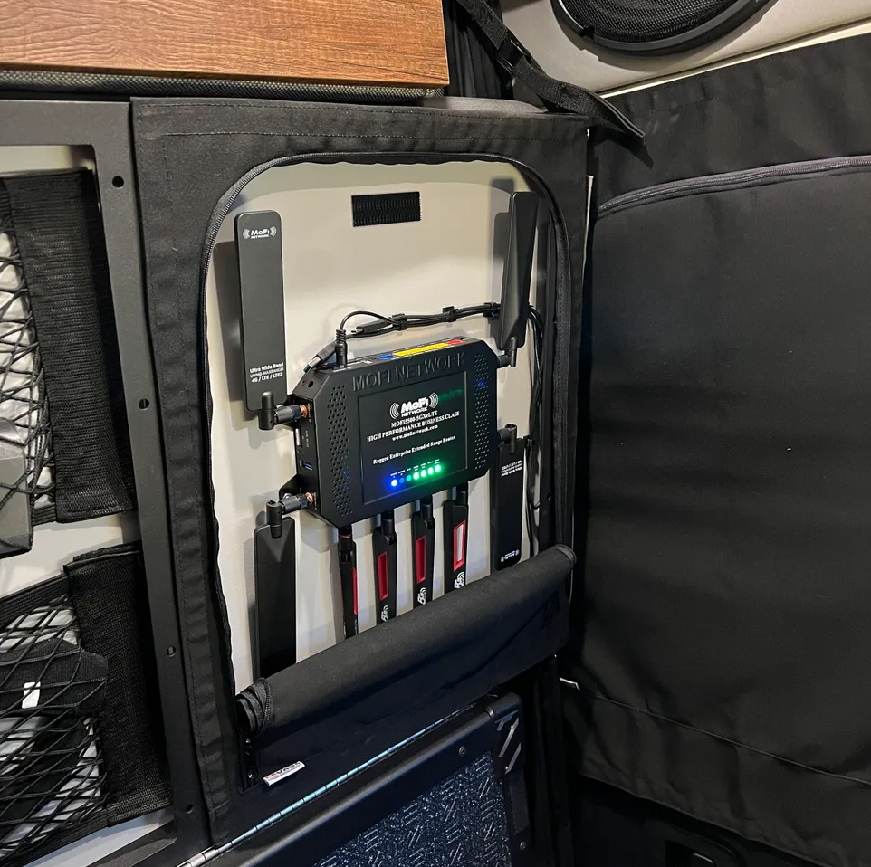 MOFI Network cellular router with antennas and SIM slots installed in an overlanding vehicle interior.