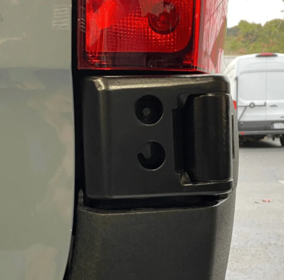 Close-up of overland vehicle rear bumper corner with taillight and mounting brackets