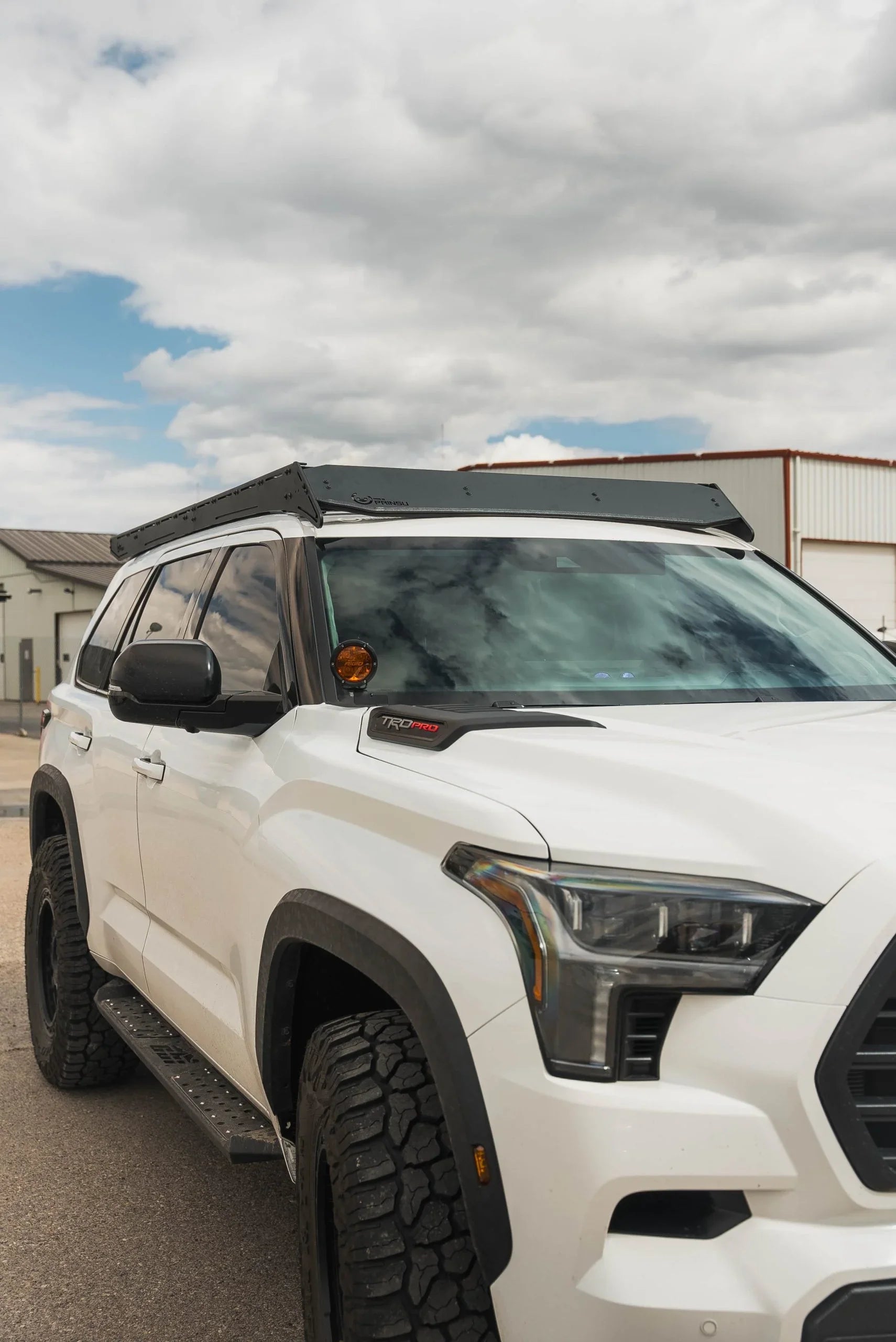Toyota SUV with overlanding roof rack, off-road tires, and TRD Pro badging outdoors
