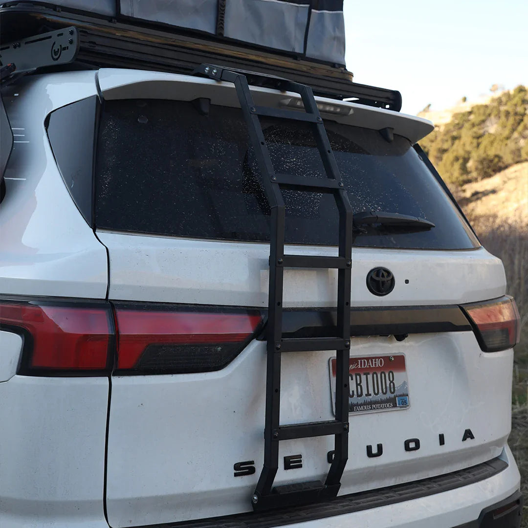 Rear view of a Toyota Sequoia with an overlanding ladder and roof rack installed