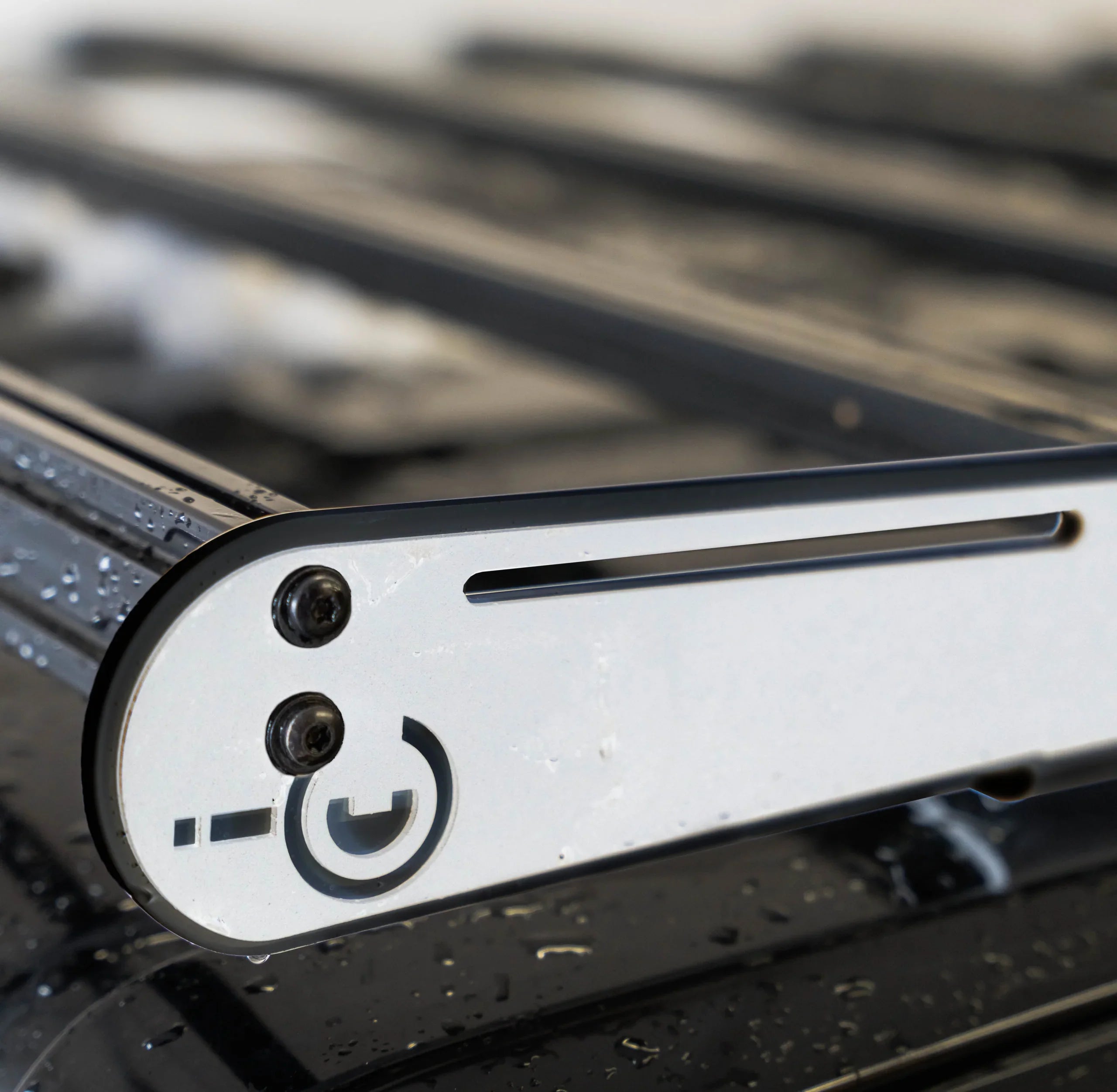 Black and white metal roof rack side rail with water droplets for overlanding vehicles