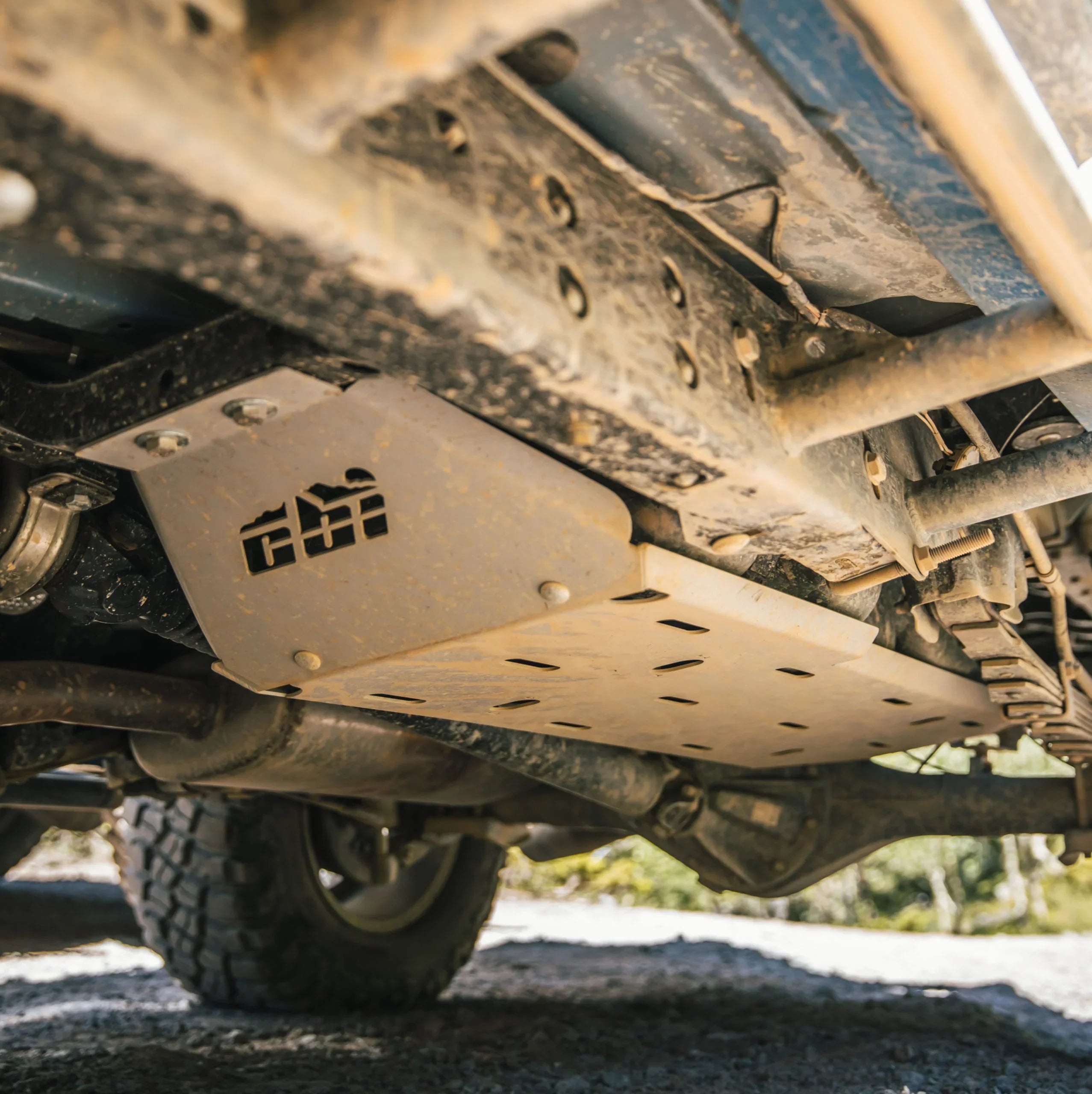 Heavy-duty steel skid plate under off-road vehicle for undercarriage protection