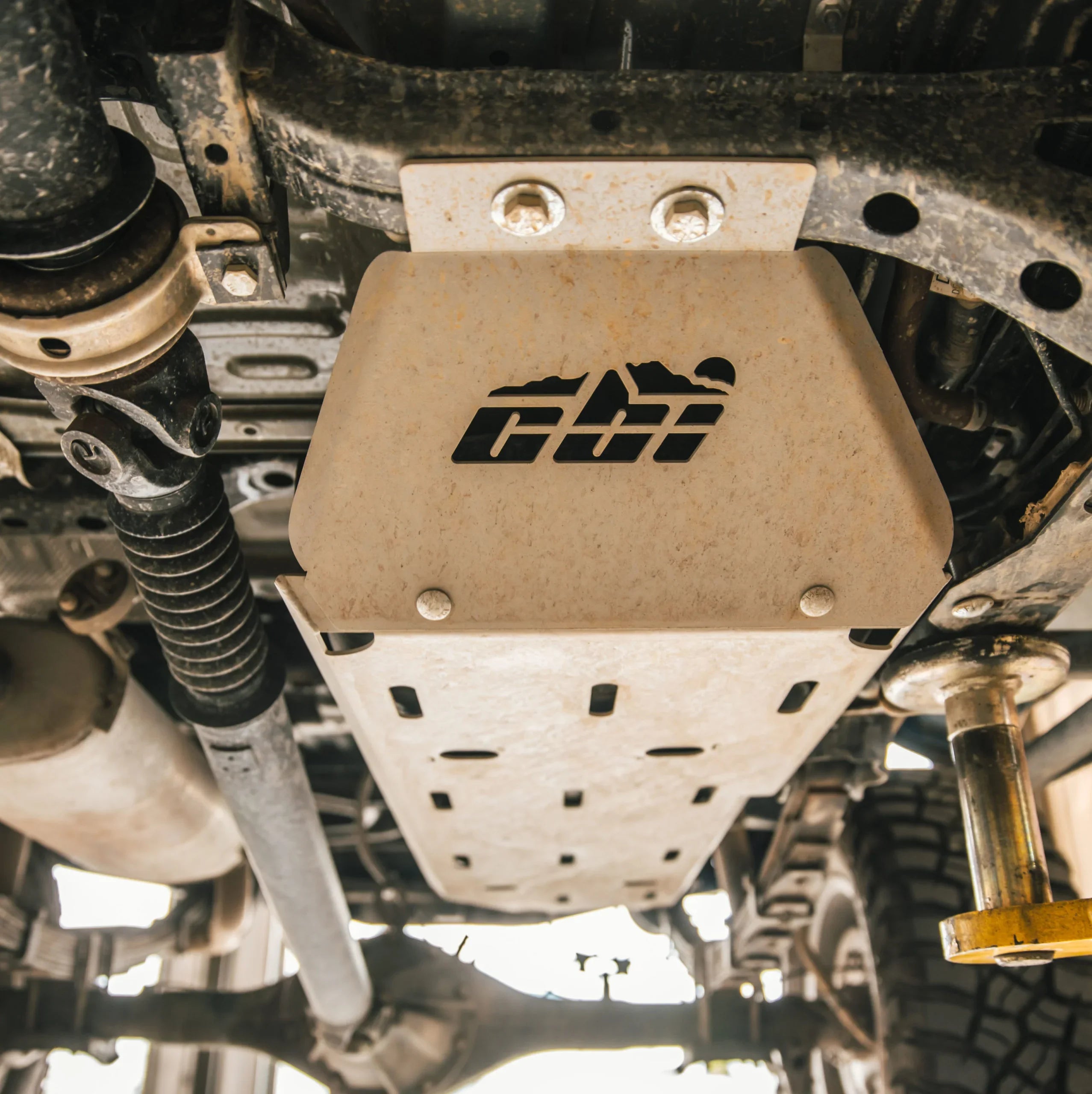 Heavy-duty skid plate installed under off-road vehicle chassis for overlanding protection
