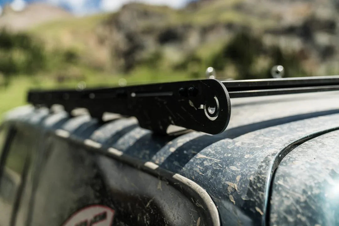 Close-up of black roof rack on dusty Toyota 4Runner for overlanding outdoors