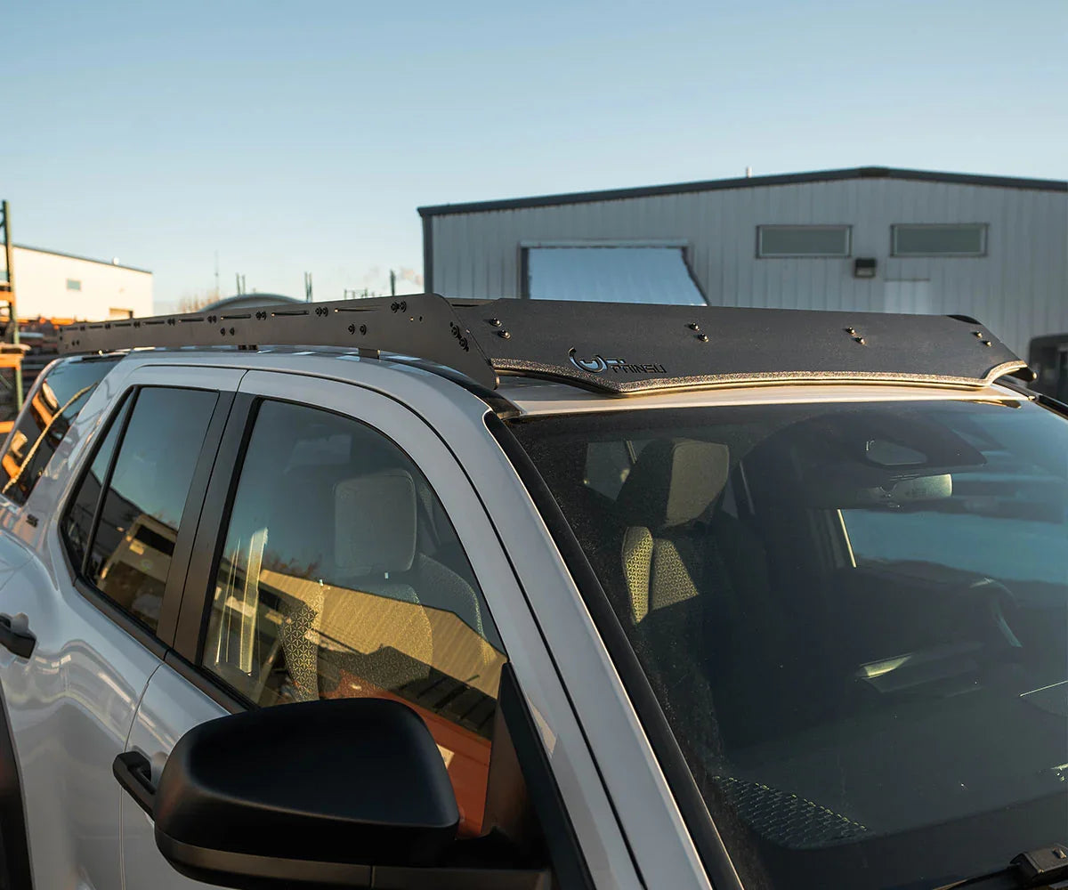 Toyota 4Runner with roof rack and wind fairing, overlanding accessory in outdoor setting